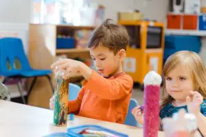 a child practicing self-care skills with Montessori dressing frames